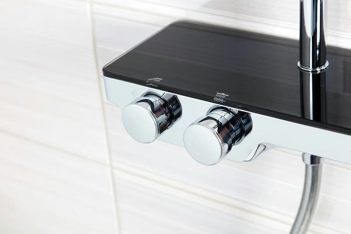 Tuš sustav SAT s termostatskom miješalicom, s nadglavnim i ručnim tušem te staklenom policom u crnoj i krom boji.