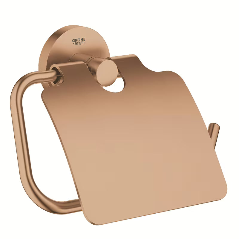 Držač toaletnog papira Grohe Essentials s poklopcem u izvedbi Brushed Warm Sunset sa skrivenim pričvršćenjem.