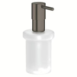 Dozator sapuna Grohe Essentials bez držača sa staklenom posudom i površinom Grohe StarLight u izvedbi hard graphite.
