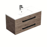 Viseća kupaonski ormarić SAT Cube Way s keramičkim umivaonikom u dekoru hrasta Wellington i crnim ručkicama.