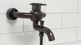 WF Industrial jednoručna baterija zidna miješalica za kadu s tuš setom u završnoj obradi uljem trljana bronca dark-metal.